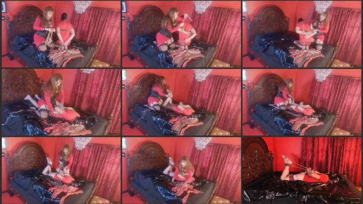 Screenshot 1 aus Redhead Julie tied up her submissive slave on the bed
